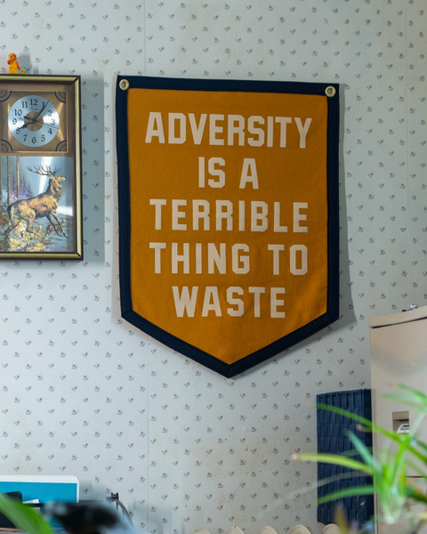 Adversity is a terrible thing to waste camp flag by Oxford Pennant Sold by Le Monkey House