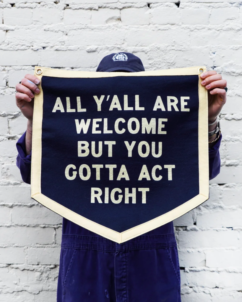 All y'all are welcome but you gotta' act right felt Camp Flag by Oxford Pennant sold by Le Monkey House