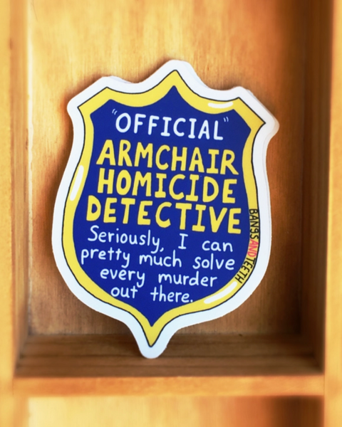 Official armchair homicide detective badge sticker by Bangs & Teeth sold by Le Monkey House