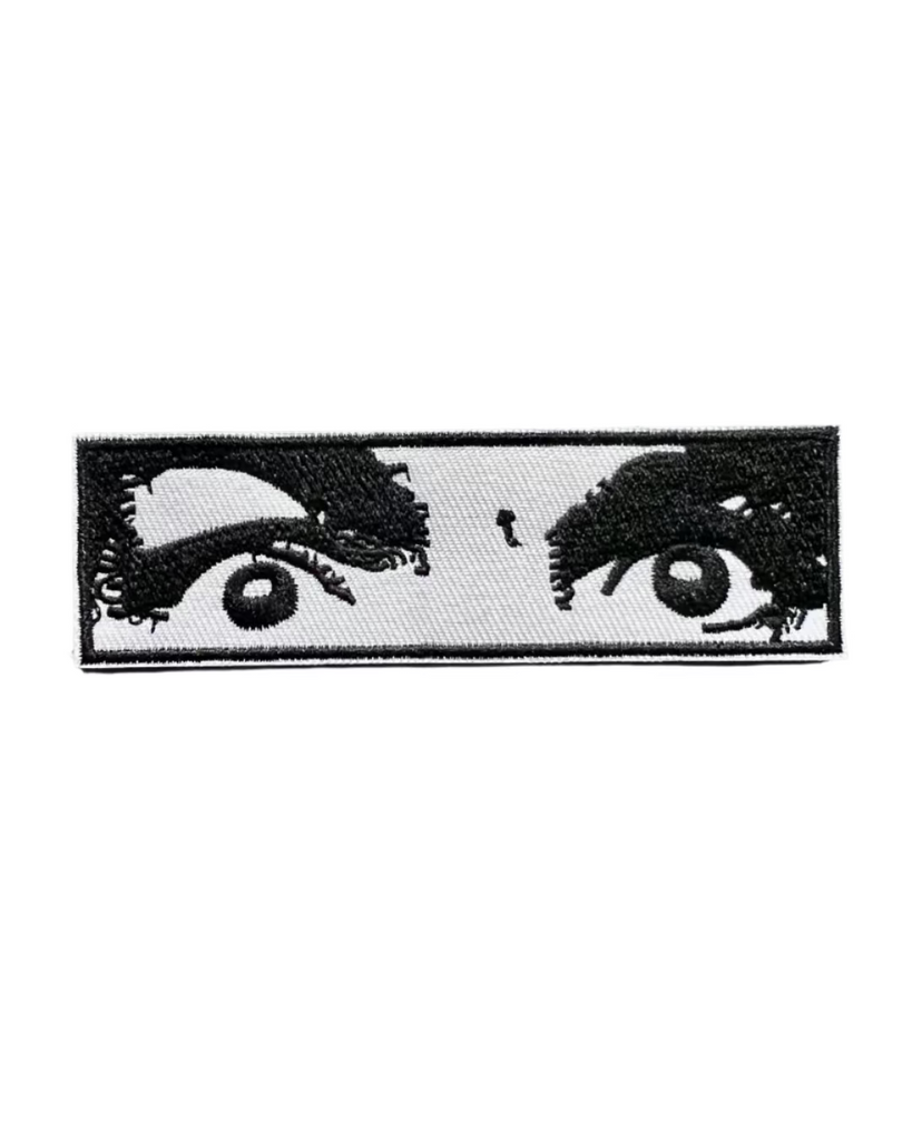Illustrated Comic Book black and white eyes embroidered iron on patch sold by Le Monkey House
