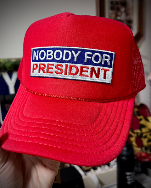 Red white and blue nobody for president Trucker hat by Le Monkey House