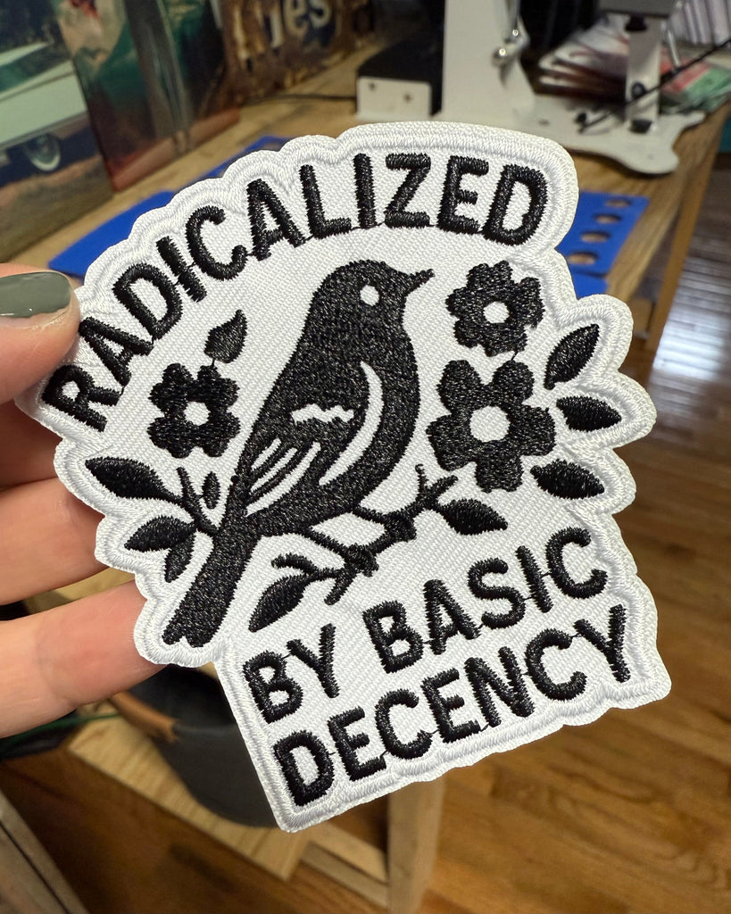 Radicalized by basic decency black bird embroidered iron on patch sold by Le Monkey House