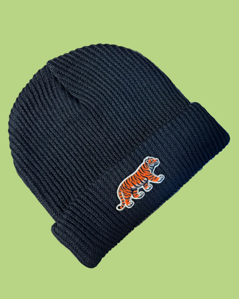 Black knit slacker beanie with embroidered orange tiger patch, sold by Le Monkey House